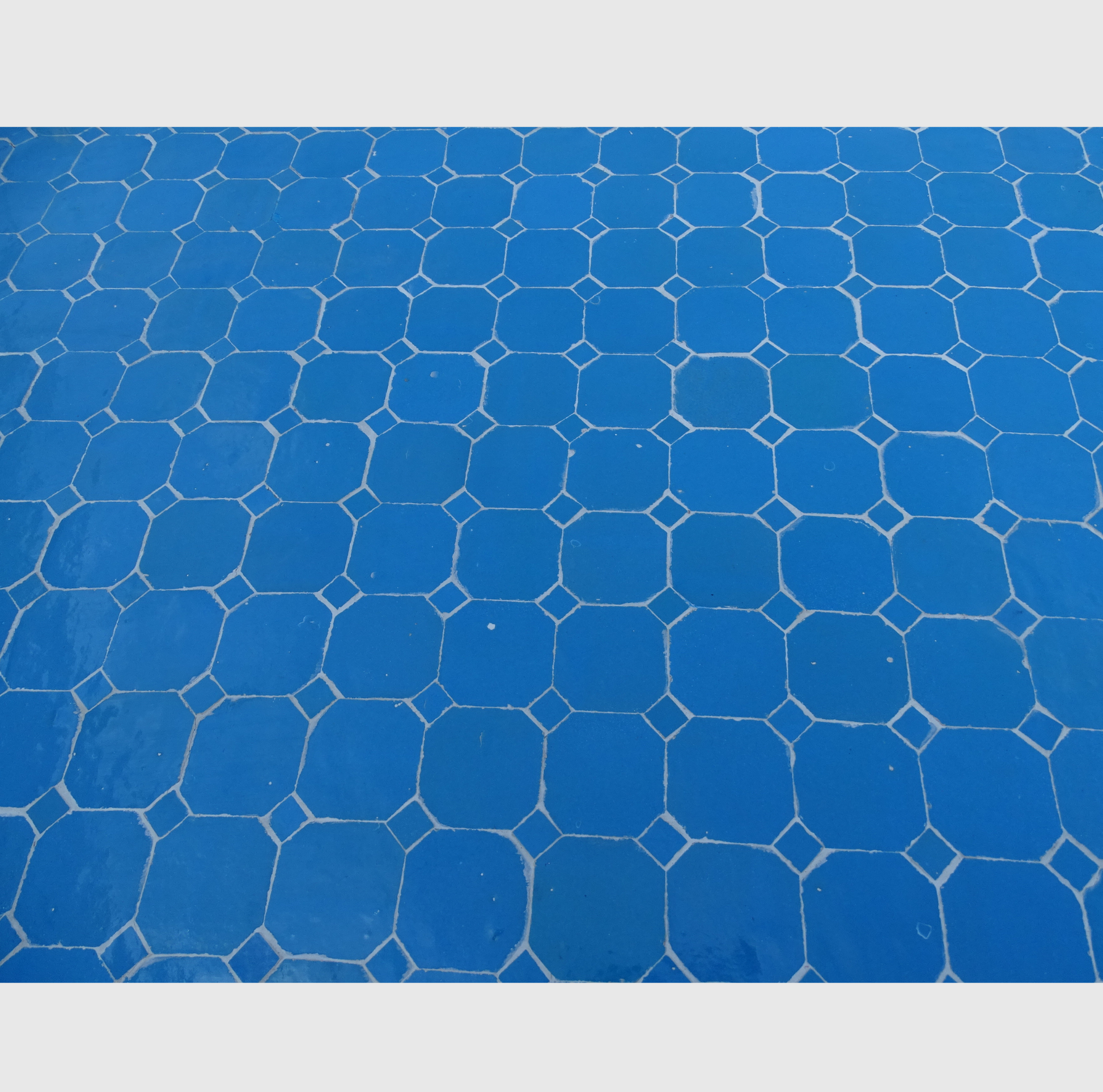 Table ovale en zellige bleu, 200x100 cm, mosaïque artisanale, piètement en fer forgé.