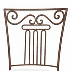 Chaise metal artisanale moustache avec dossier decoratif en fer forge finition rouille naturelle