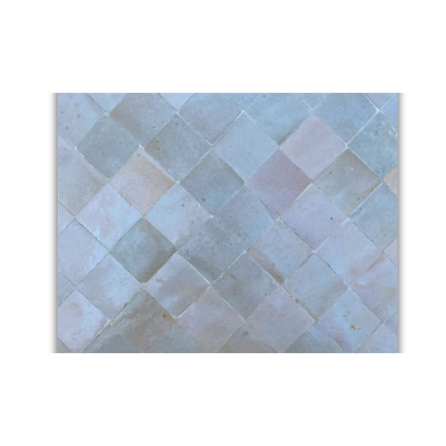 Détail du plateau en mosaïque marocaine zellige bordeaux et beige posé à la main sur table rectangulaire