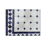 Table en zellige 150 × 100 cm Blanc avec cabochons bleus – Table artisanale marocaine avec pied pliable en fer forgé rouillé